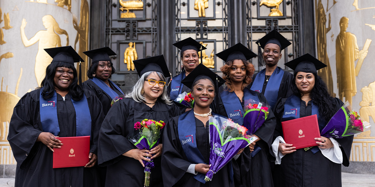 Bard at BPL grads in their robes on the steps of Brooklyn Central Library