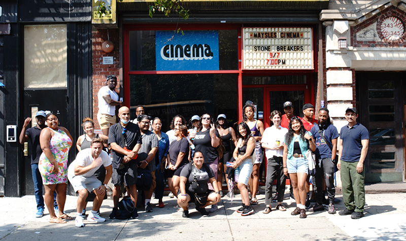 Harlem Microcollege students pose for a photo on the sidewalk.